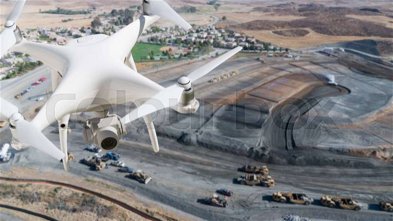 Unmanned Aircraft System (UAV) Quadcopter Drone In The Air Over Construction Site, stock photo