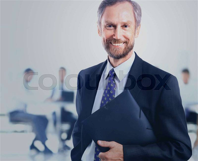 Portrait of an elegant mature business man in the office, stock photo