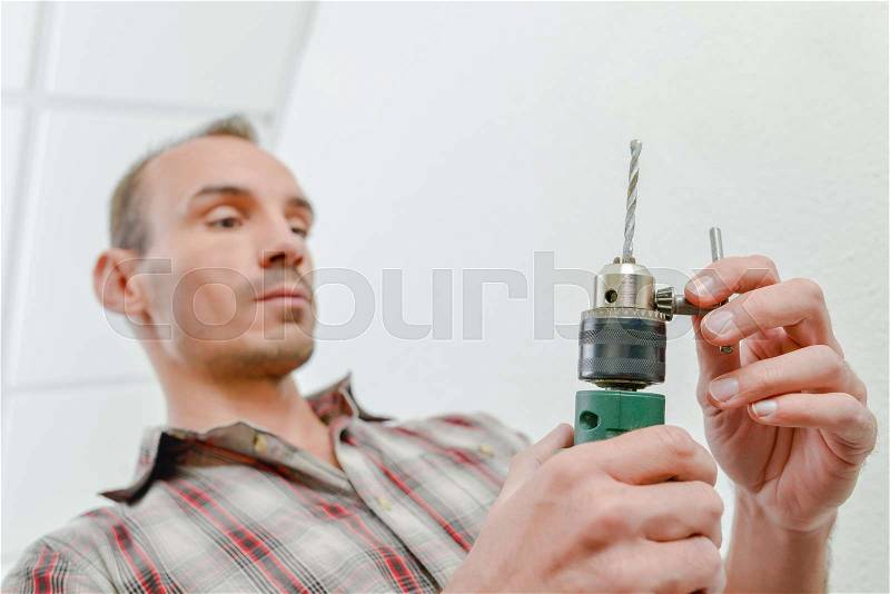 Builder holding power drill, stock photo