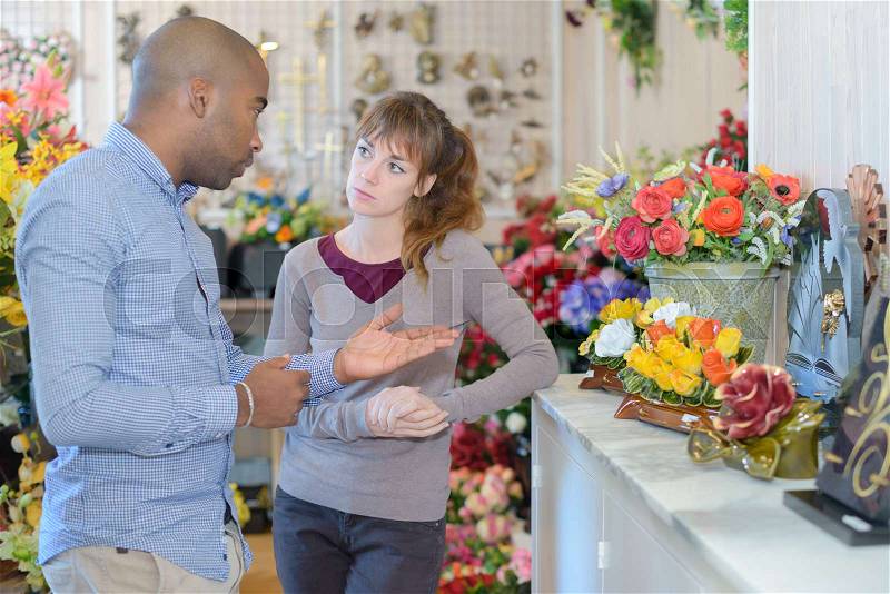 Person choosing funeral flowers, stock photo