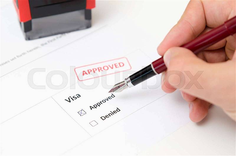 Visa and approved stamp on a document form. Immigration and travel concept, stock photo