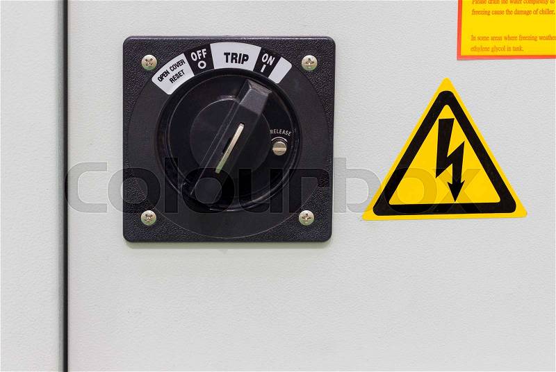 Industrial on / off switch for electrical cabinet for machine ; factory equipment , stock photo