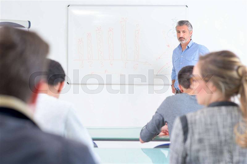 Teacher writing on the white board, stock photo