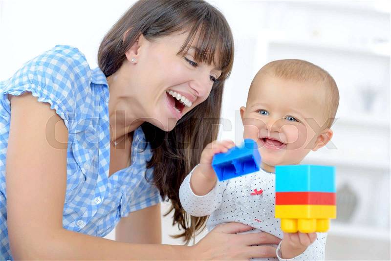 Mom and baby playing together, stock photo