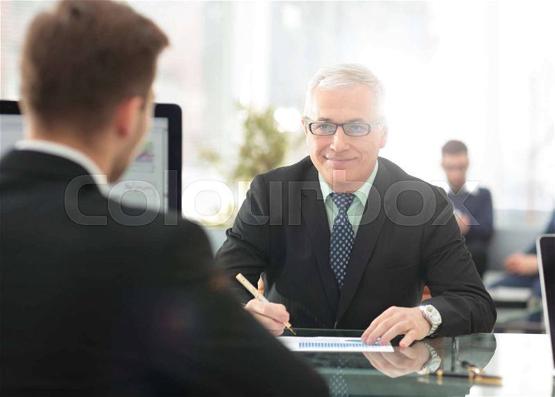 Project Manager conducts an interview with a new employee in a modern office, stock photo