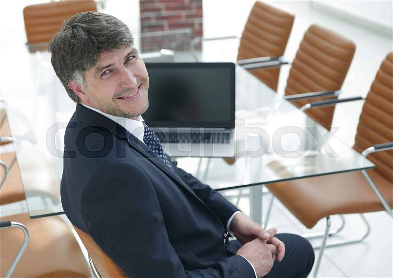 Manager sitting at work desk in meeting room. Business people, stock photo