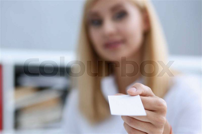 Smiling businesswoman holding hand in white shirt give blank calling card. White collar partners company name exchange executive or ceo introducing at conference product consultant sale clerk concept, stock photo