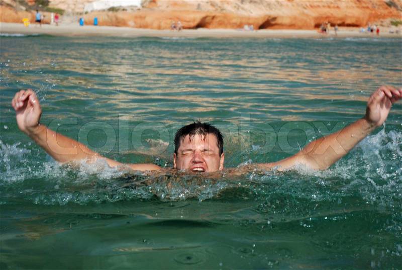Man drowning in the sea, stock photo