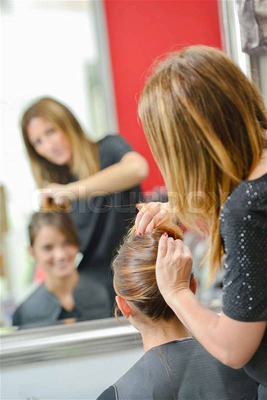 Woman having her hair done, stock photo