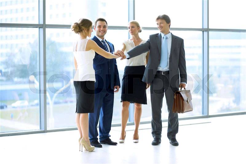 Business people group joining hands and representing concept of friendship and teamwork, stock photo