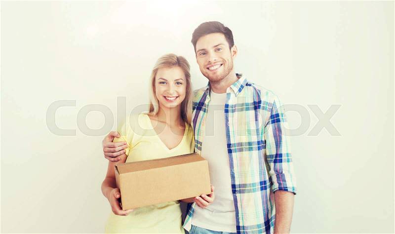 People, delivery, mail, shipping and moving concept - smiling couple with cardboard box, stock photo