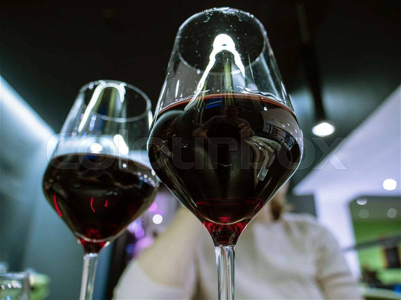 Two glasses of red organic wine shared with male female partner at dinner in a restaurant, stock photo