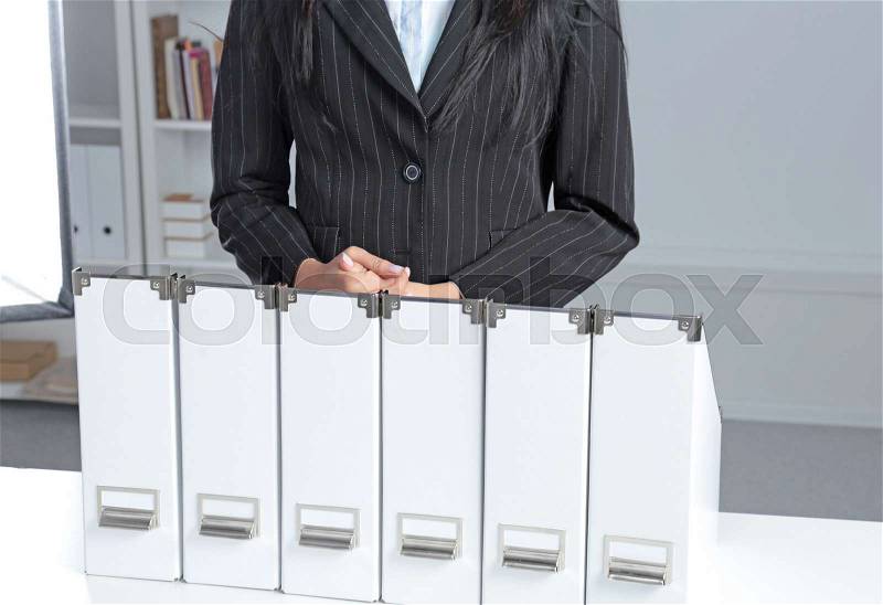 Business women leaning on a folder in the office , stock photo