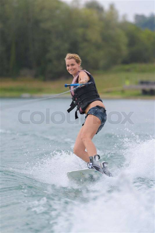 Woman water skiing on a lake, stock photo