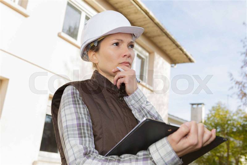 Thoughtful female health and safety inspector, stock photo