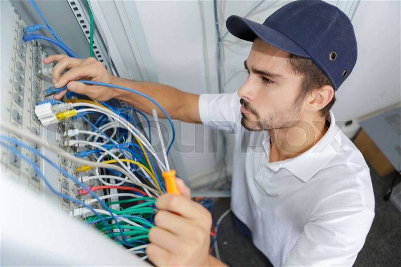 Electrician wiring electrical panel, stock photo