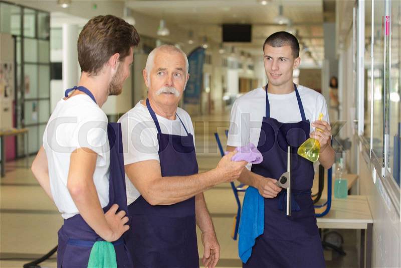 Male cleaning team on indoor job, stock photo