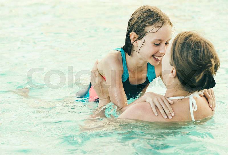 Mother and her daughter having fun in SPA, stock photo