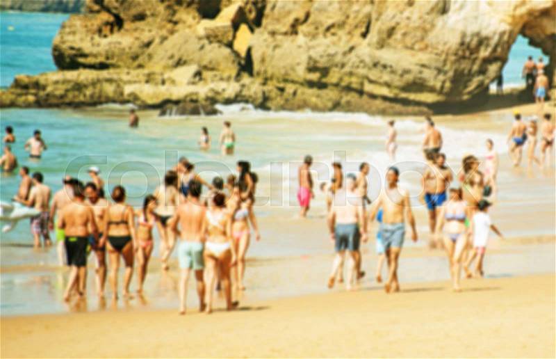 Lot of people resting on the summer beach. Blurred image, stock photo