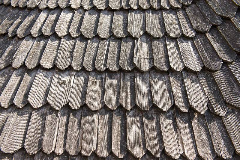 Old wooden roof with dry leaves on it. Abstract architectural background and patter, stock photo