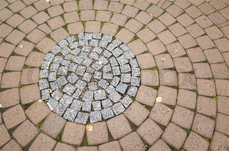 Cobble road, round pattern of a stone street pavement, background photo texture, stock photo