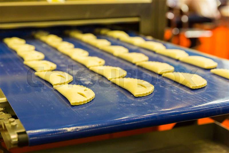 Professional bakery equipment, pastry conveyor machine. Food preparing, technology line, stock photo