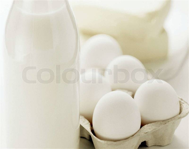 Fresh eggs and dairy products in glass containers, stock photo