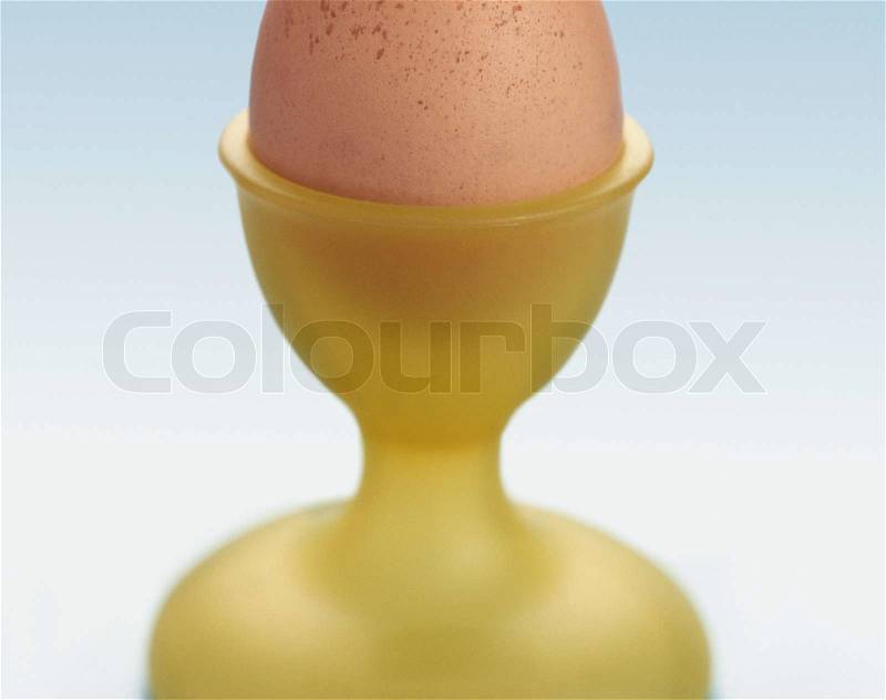 Boiled egg in an egg cup, stock photo