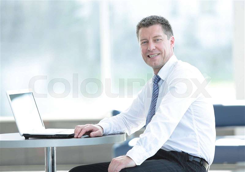 Happy middle aged business man working on computer, stock photo