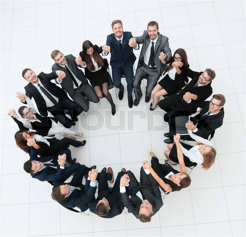 Successful business team sitting in a circle and took each other\'s hands. photo with copy space, stock photo