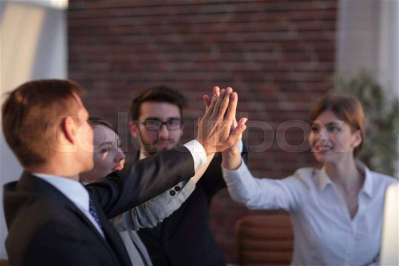 Successful business team giving each other a high five. the concept of success, stock photo