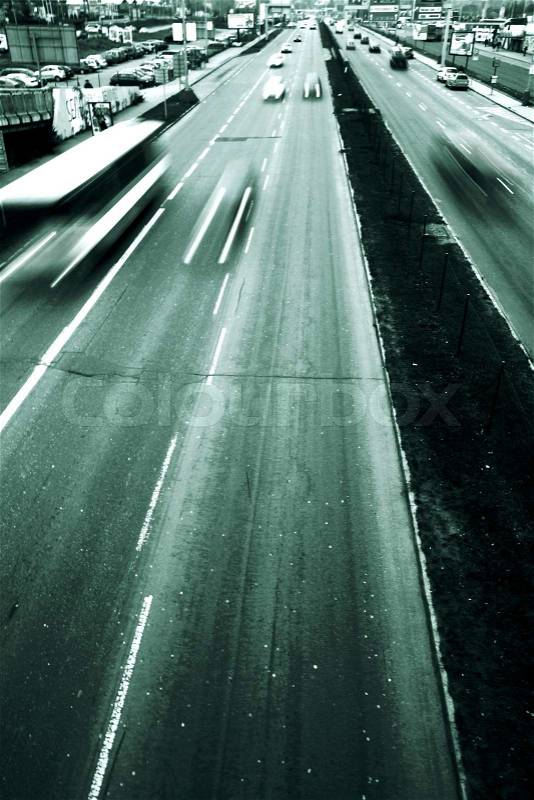Highway with lots of cars. Green tint, high contrast and motion blur to rise speed. Down with place for text, stock photo