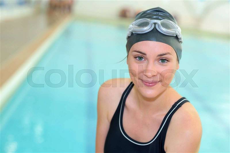 Portrait of swimmer at indoor pool, stock photo