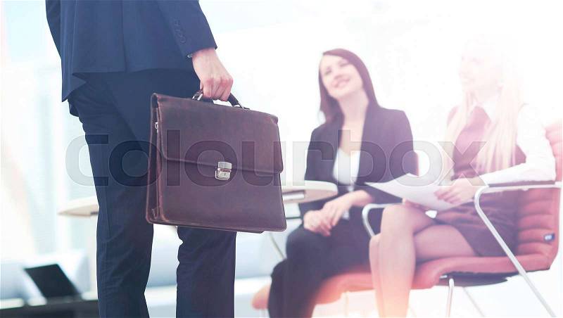 Close up portrait of a business man with briefcase and collegue, stock photo