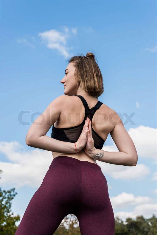 Bottom view of woman in Reverse Prayer Pose while practicing yoga, stock photo