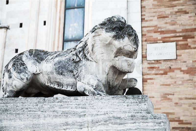 Ancient lion, white weathered statue. Fermo, Italy, stock photo