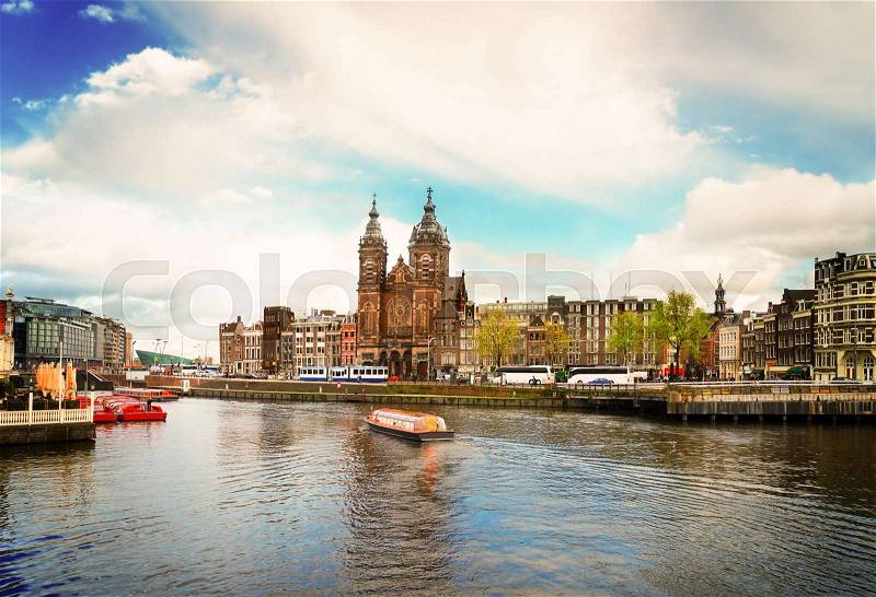Amsterdam skyline with Church of St Nicholas over old town canal, Amsterdam, Holland, retro toned, stock photo