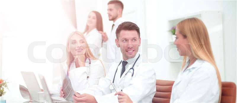 Smiling doctors working at office desk and smiling, medical office, stock photo