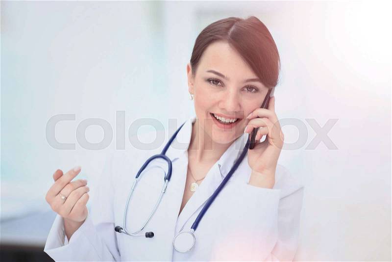Doctor talking on telephone, stock photo