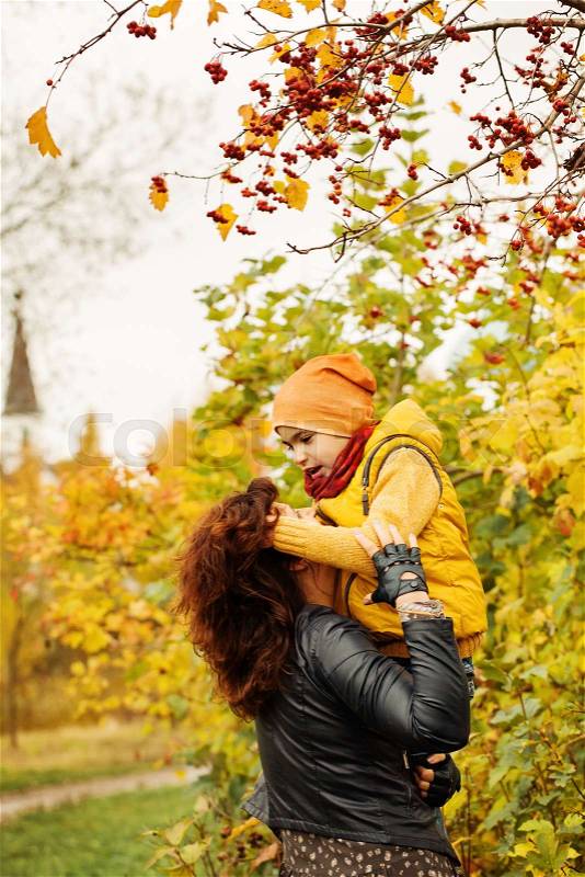 Autumn Family. Loving Mother and Son in Fall Park Outdoors, stock photo