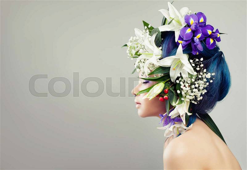 Beautiful Asian Model Woman with Floral Hairstyle and Perfect Makeup. Fashion Girl with White Lily and Iris Flowers, stock photo