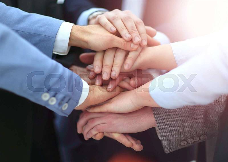 Creative team putting their hands together in circle, stock photo