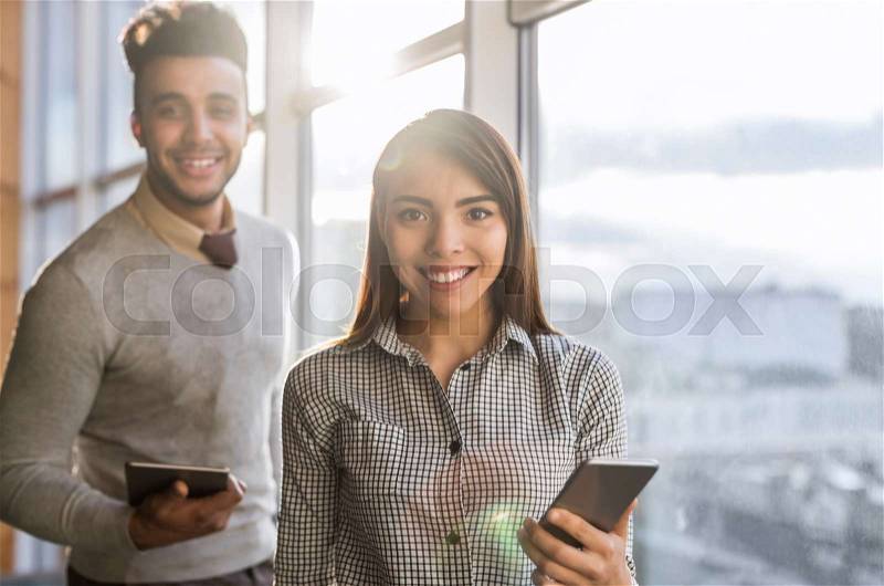 Mix Race Business Man Woman Using Cell Smart Phone Stand In Front Panoramic Window Happy Smiling Businesspeople Coworking Center Office Interior, stock photo