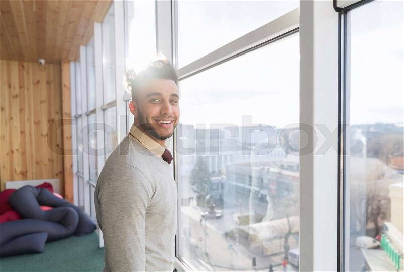 Hispanic Business Man Stand In Front Panoramic Window Happy Smiling Businessman Coworking Center Office Interior, stock photo