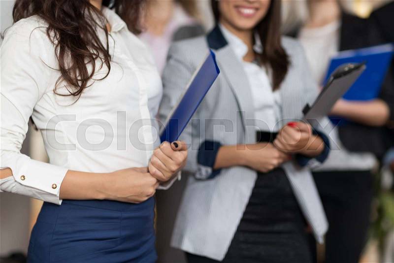 Hotel Administrator Meeting Business People In Lobby, Woman Receptionists Closeup Guests Arrive, stock photo