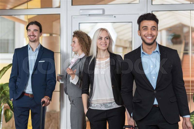 Business People In Hotel Lobby, Mix Race Businesspeople Group Guests Arrive Entrance With Suitcase, stock photo