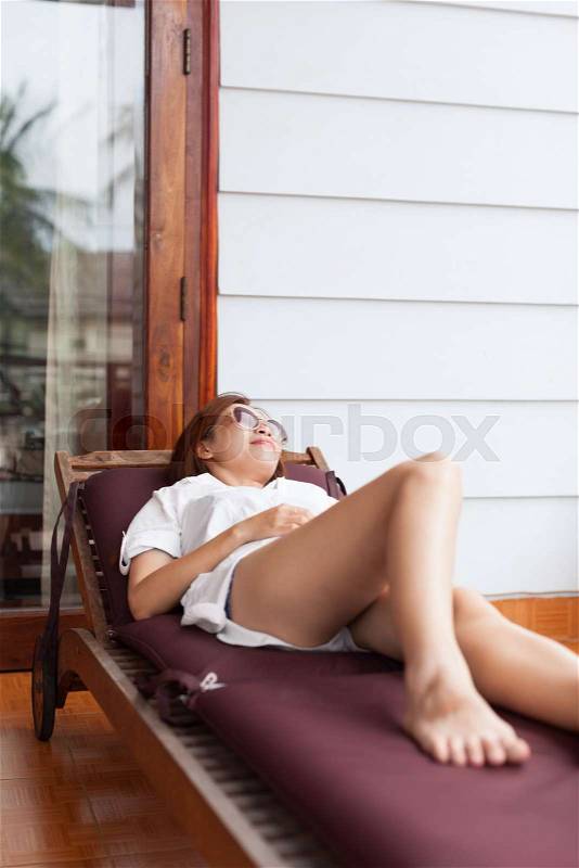 Beautiful Woman Lying On Deck Chair Terrace Relaxed Slim Legs Young Asian Girl, stock photo