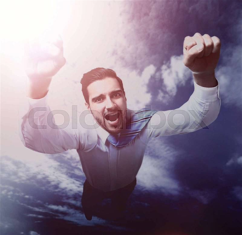 Happy businessman flying in the sky, stock photo