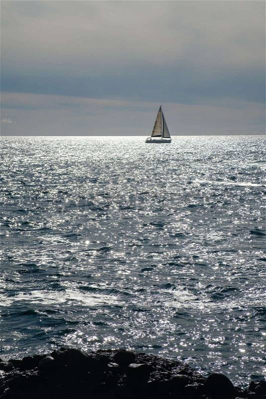 Sail boat at horizon line. Pacific ocean. view from Tenerife beach. outdoor shot. copy space, stock photo