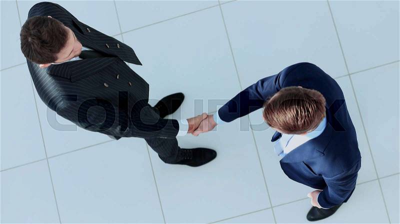 Top view of a two businessman shaking hands - Welcome to business, stock photo